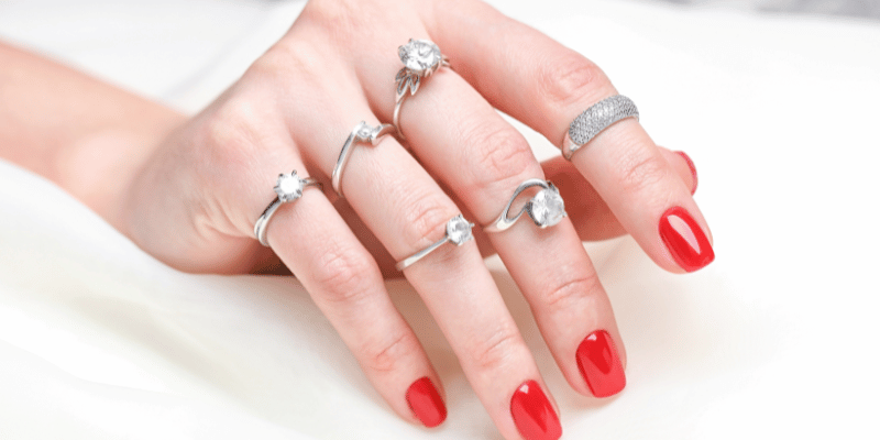 Different solitaire rings on hand